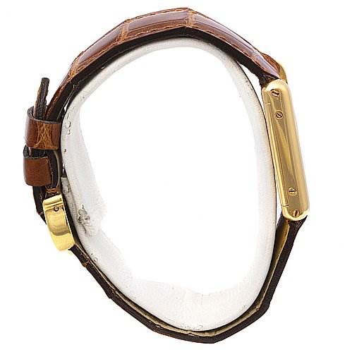 The image shows a side view of the Cartier Tank Classic Women's Yellow Gold White Dial Women's Yellow Gold White Dial watch, displaying its gold casing and brown leather strap.