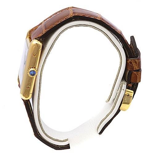 The image shows the side view of a Cartier Tank Classic Women's Yellow Gold White Dial Women's Yellow Gold White Dial watch, highlighting its crown and brown leather strap.