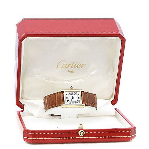 The Cartier Tank Classic Women's Yellow Gold White Dial Women's Yellow Gold White Dial watch is displayed in an open, red Cartier box, showing the front face and brown leather strap.