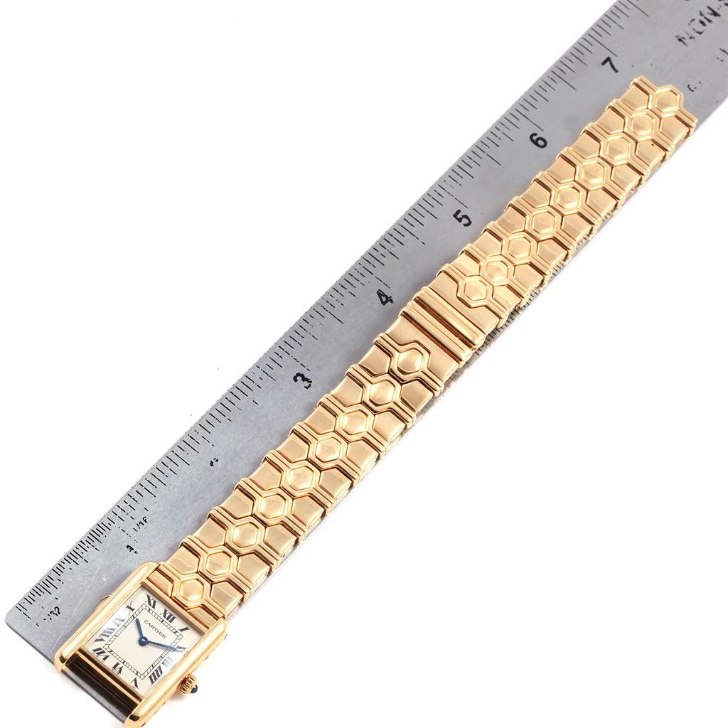 The image shows a Cartier Tank Classic Women's Yellow Gold Silver Dial Women's Yellow Gold Silver Dial watch laid flat next to a ruler, highlighting the watch band and rectangular face.