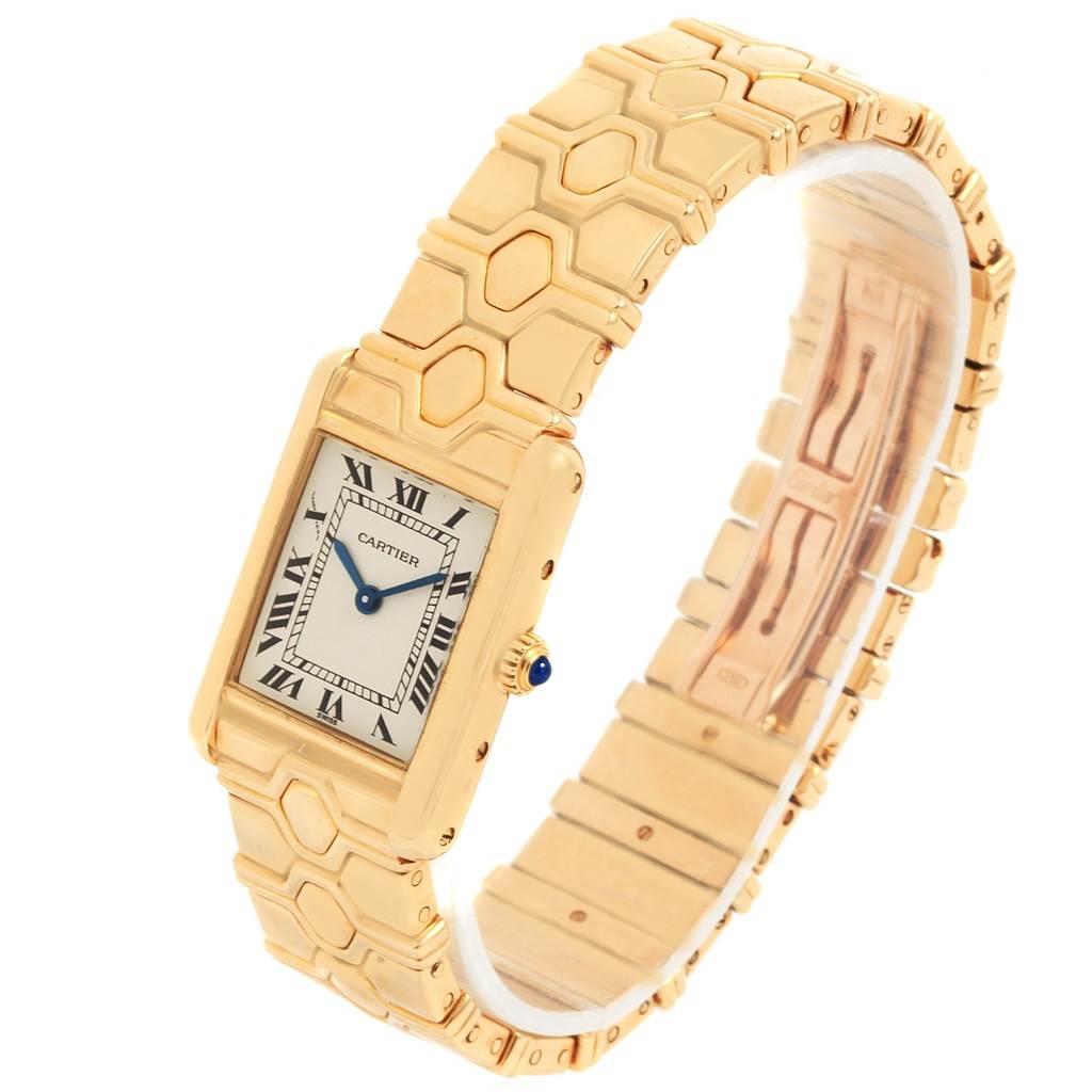 The Tank Classic model by Cartier is shown at an angle displaying the face with Roman numerals, blue hands, and a gold hexagonal link band.