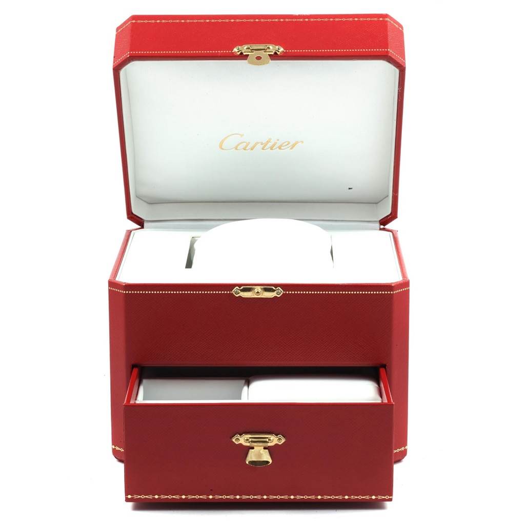 This image shows a red Cartier watch box for the Tank Classic model, with the lid open and a drawer pulled out.