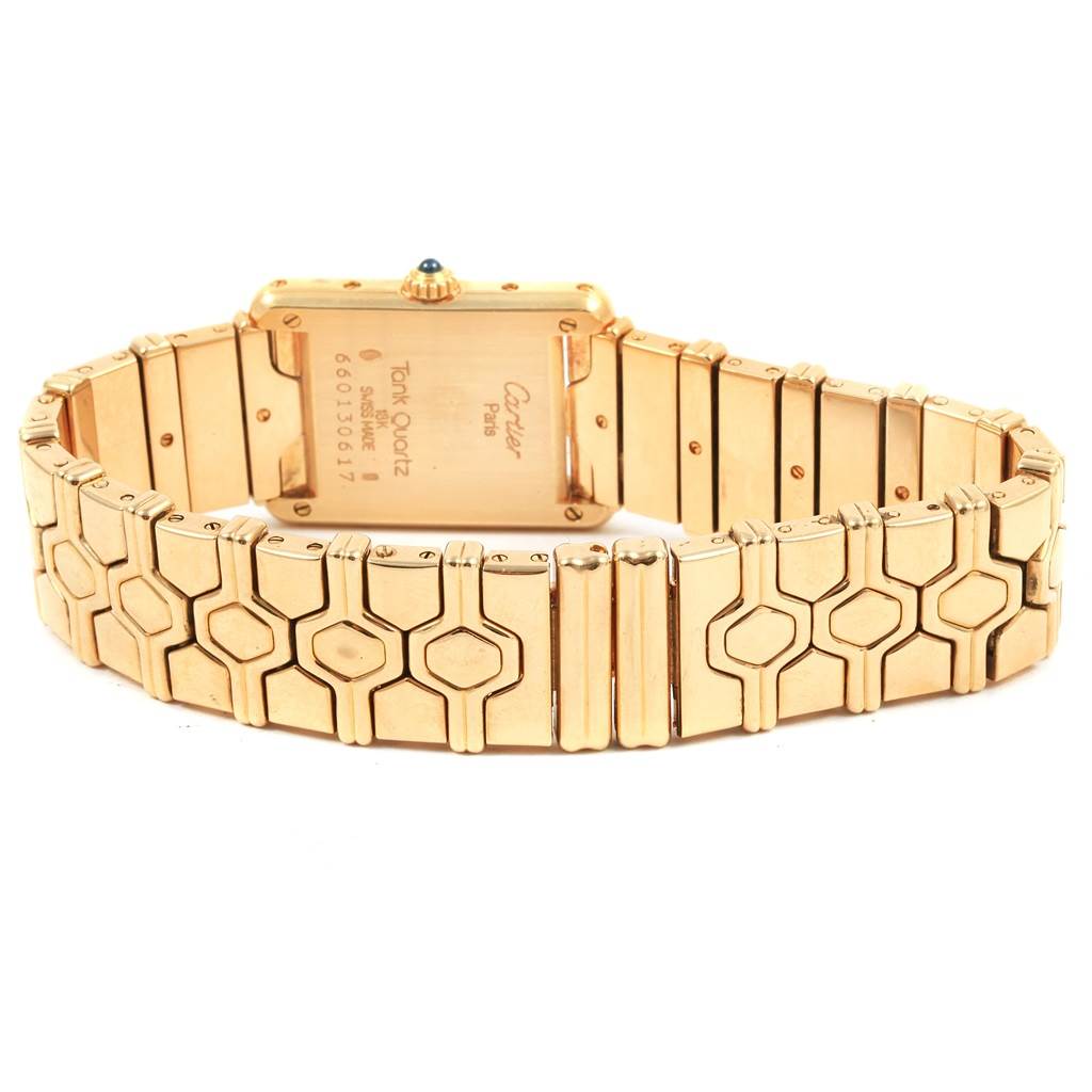 This image shows the back view of the Cartier Tank Classic Women's Yellow Gold Silver Dial Women's Yellow Gold Silver Dial watch, highlighting its gold bracelet and case.