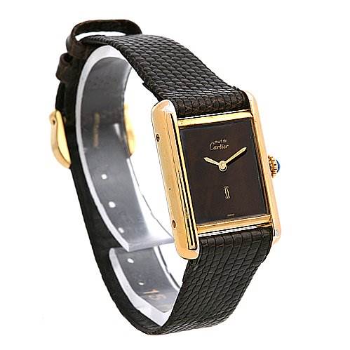 The image shows a Cartier Tank Classic Women's Yellow Gold Brown Dial Women's Yellow Gold Brown Dial watch at a three-quarters angle, highlighting its black strap and golden rectangular case.