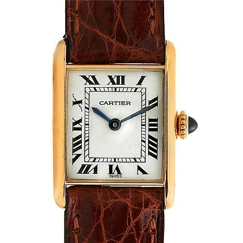 The image shows the face and brown leather strap of a Cartier Tank Classic Women's Yellow Gold White Dial Women's Yellow Gold White Dial watch with Roman numerals and a gold case.