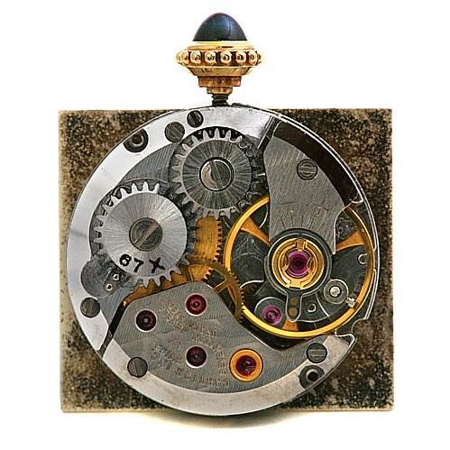 This image shows the internal mechanism and gears of a Cartier Tank Classic Women's Yellow Gold White Dial Women's Yellow Gold White Dial watch from the back.