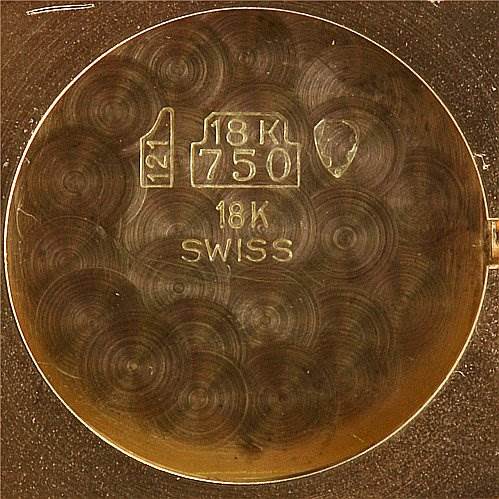 This is the interior view of the case back of a Cartier Tank Classic Women's Yellow Gold White Dial Women's Yellow Gold White Dial watch, showing the "18K 750" gold mark and "SWISS" engraving.