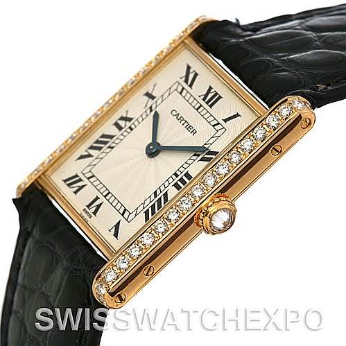 The image shows a Cartier Tank Classic Women's Yellow Gold Silver Dial Women's Yellow Gold Silver Dial watch from an angle highlighting the diamond-encrusted bezel, dial, and part of the leather strap.