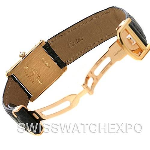 The image shows the back view of a Cartier Tank Classic Women's Yellow Gold Silver Dial Women's Yellow Gold Silver Dial watch, highlighting its clasp, gold case back, and leather strap.