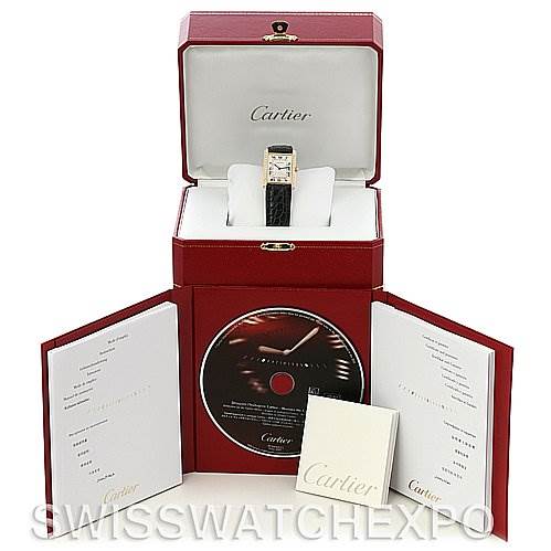 The image shows a Cartier Tank Classic Women's Yellow Gold Silver Dial Women's Yellow Gold Silver Dial watch inside its open case, along with a CD and booklets.