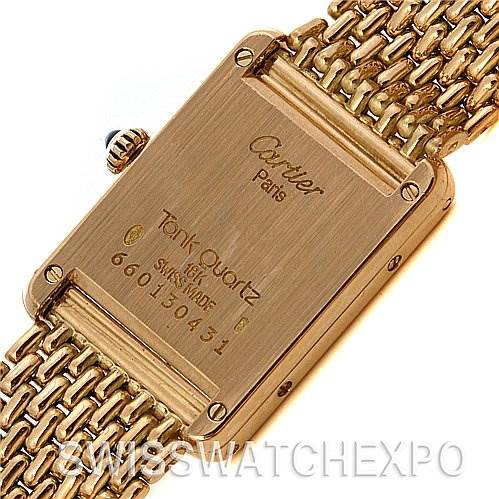 The image shows the back of a Cartier Tank Classic Women's Yellow Gold White Dial Women's Yellow Gold White Dial Quartz model, including the screw-on case back and part of the gold bracelet.