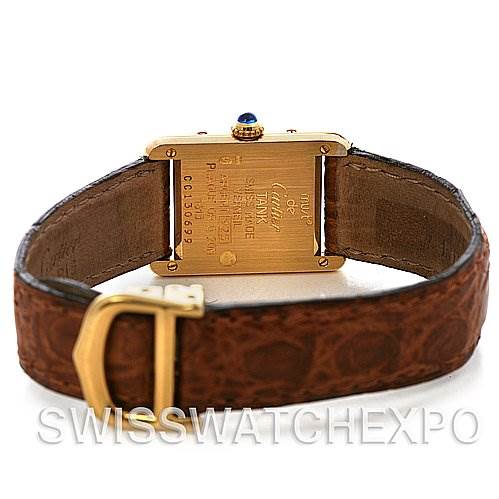 The image shows the backside of a Cartier Tank Classic Women's Yellow Gold White Dial Women's Yellow Gold White Dial watch, highlighting the case back, crown, and leather strap with buckle.