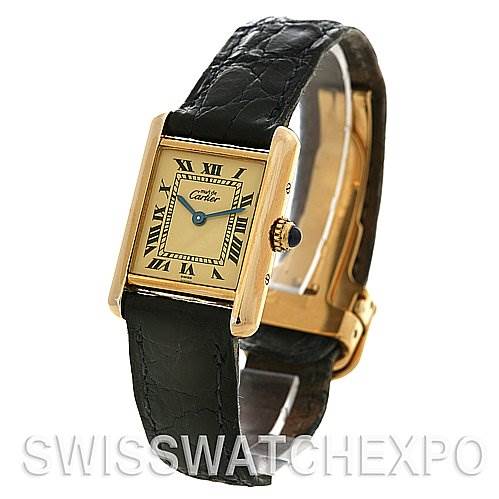 The Cartier Tank Classic Women's Yellow Gold Beige Dial Women's Yellow Gold Beige Dial watch is shown at a slight angle, highlighting the face, strap, crown, and clasp.