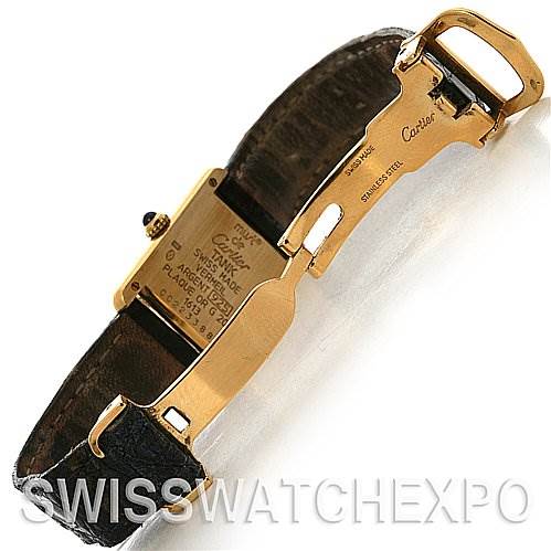 The image shows the underside of the Tank Classic model by Cartier, focusing on the clasp, strap, and case back.