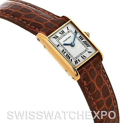 The image shows a Cartier Tank Classic Women's Yellow Gold White Dial Women's Yellow Gold White Dial watch angled from the front-top with a brown leather strap, and a gold rectangular case.