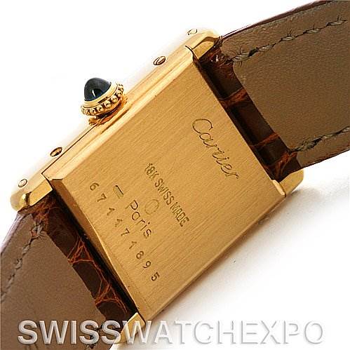 This image shows the back case and brown leather strap of the Cartier Tank Classic Women's Yellow Gold White Dial Women's Yellow Gold White Dial watch at an angle.
