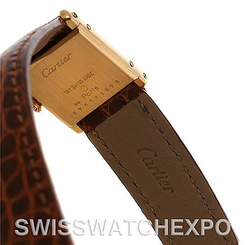 The image shows the back case and leather strap of a Cartier Tank Classic Women's Yellow Gold White Dial Women's Yellow Gold White Dial model watch at an angled view.