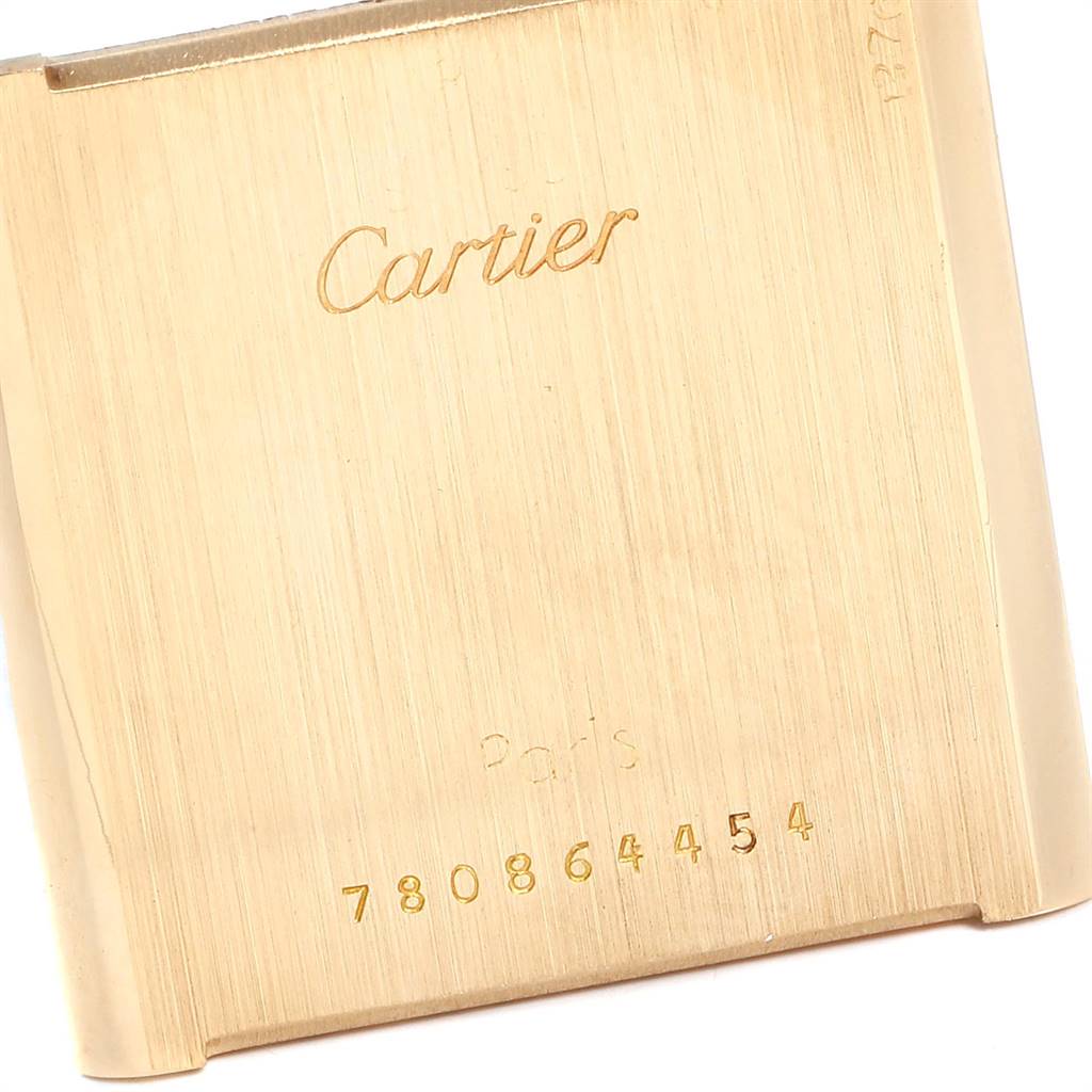 This image shows the back case of the Cartier Tank Classic Women's Yellow Gold White Dial Women's Yellow Gold White Dial watch, highlighting the brand name and serial number.