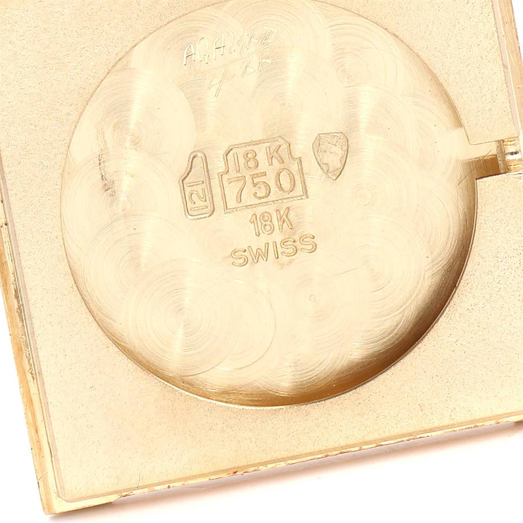 This is an image of the back cover of a Tank Classic model by Cartier, showcasing its 18K gold marking.