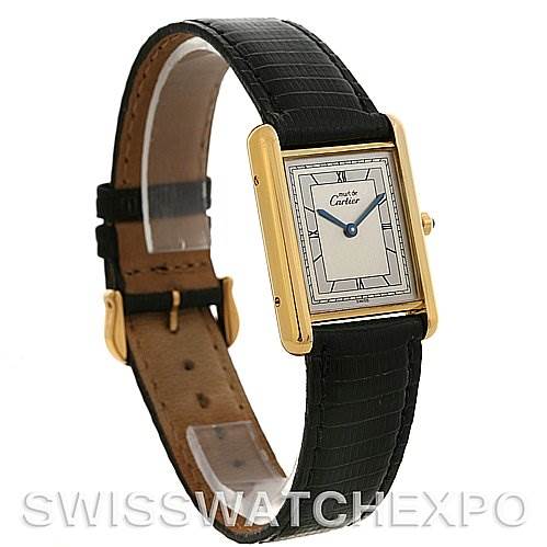 The image shows a Cartier Tank Classic Yellow Gold Silver Dial Yellow Gold Silver Dial watch at an angle highlighting the face, leather strap, and gold-tone casing.