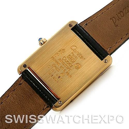 This image shows the back case and leather straps of a Cartier Tank Classic Yellow Gold Silver Dial Yellow Gold Silver Dial watch, highlighting its engravings and details.