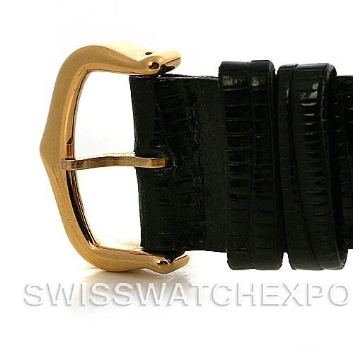 This image shows the buckle portion of a Cartier Tank Classic Yellow Gold Silver Dial Yellow Gold Silver Dial watch strap, angled to highlight the gold finish and black leather.