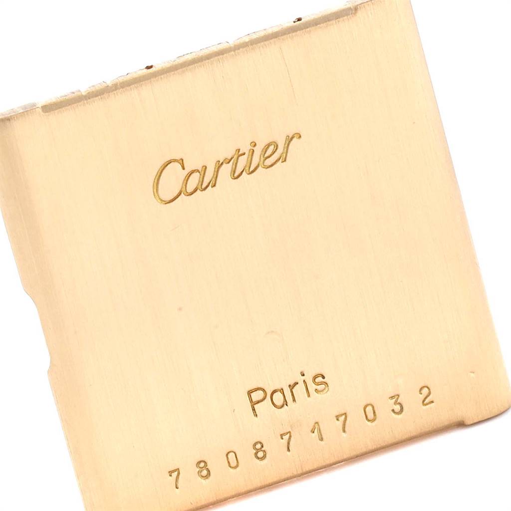 The image shows the backplate of a Cartier Tank Classic Women's Yellow Gold White Dial Women's Yellow Gold White Dial watch, featuring the brand's name and a serial number.