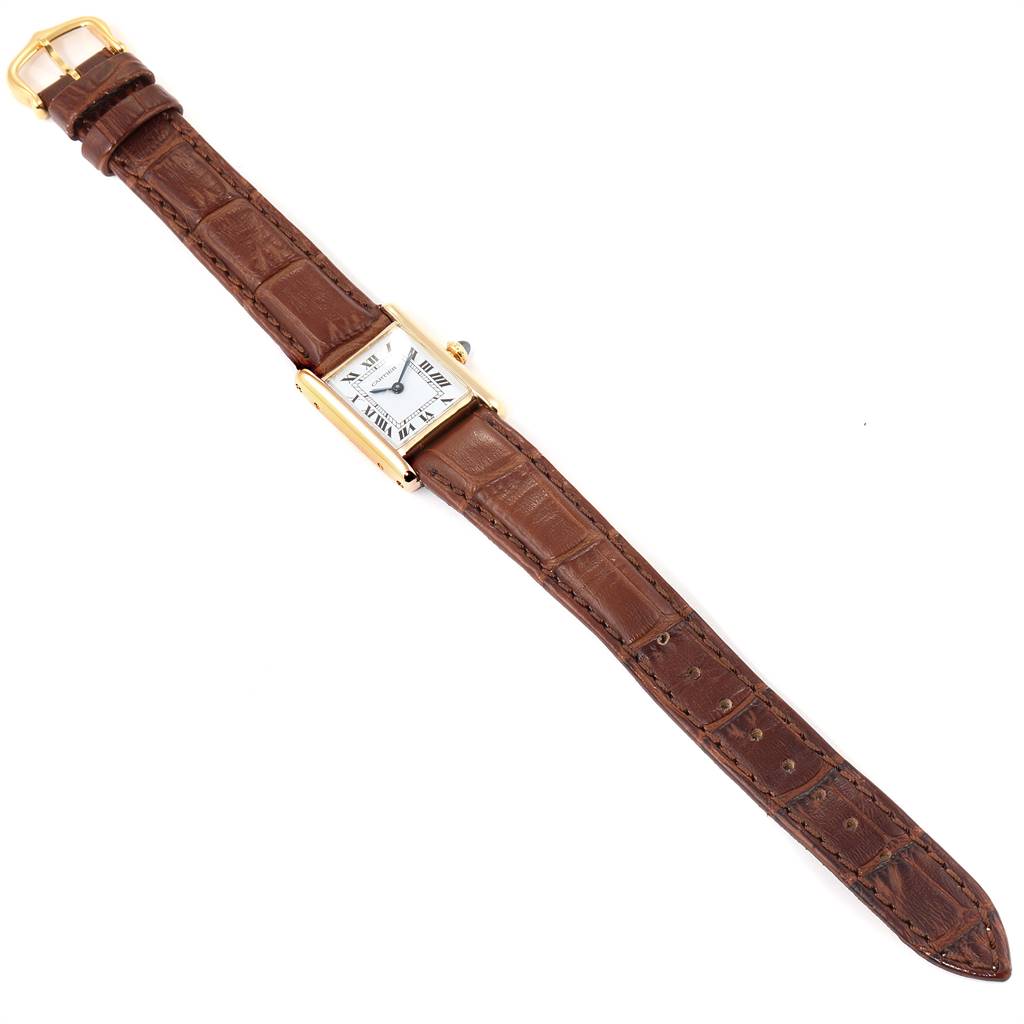 This image shows a Cartier Tank Classic Women's Yellow Gold White Dial Women's Yellow Gold White Dial watch laid flat, displaying the full brown leather strap and rectangular face.