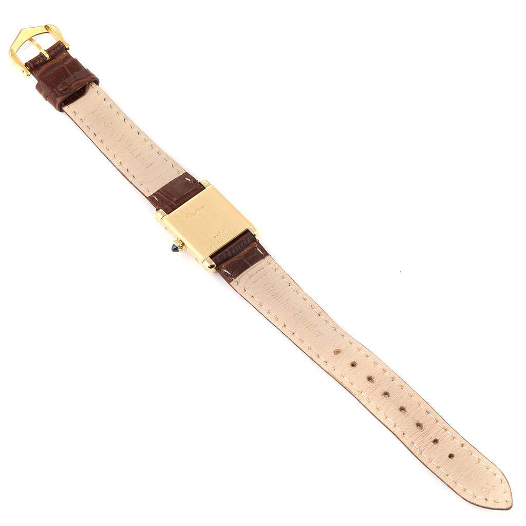 The image shows the back view of a Cartier Tank Classic Women's Yellow Gold White Dial Women's Yellow Gold White Dial watch, including its brown leather strap and gold case.