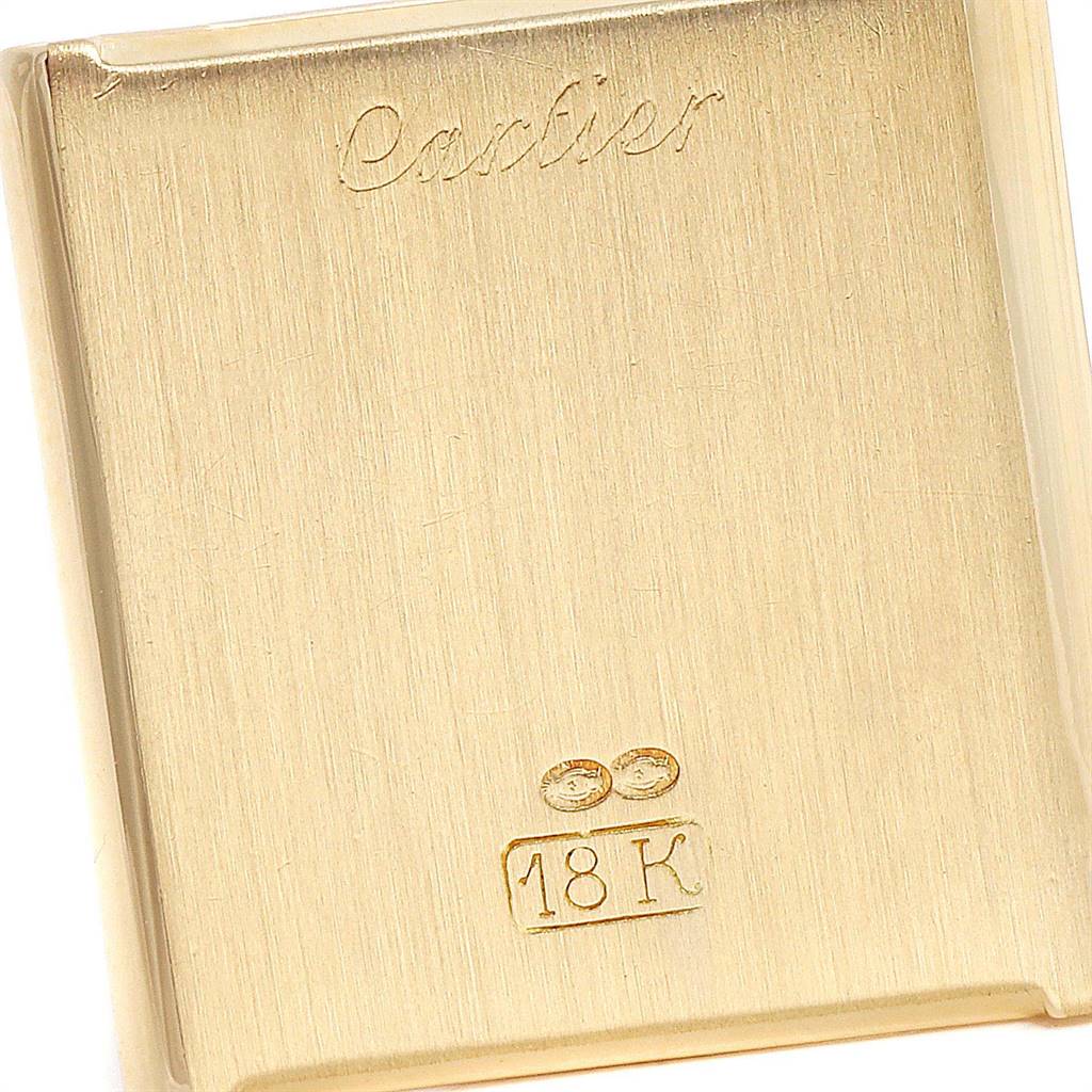 This is the back view of a Cartier Tank Classic Women's Yellow Gold White Dial Women's Yellow Gold White Dial watch, showing the "Cartier" inscription and an 18K gold marking.