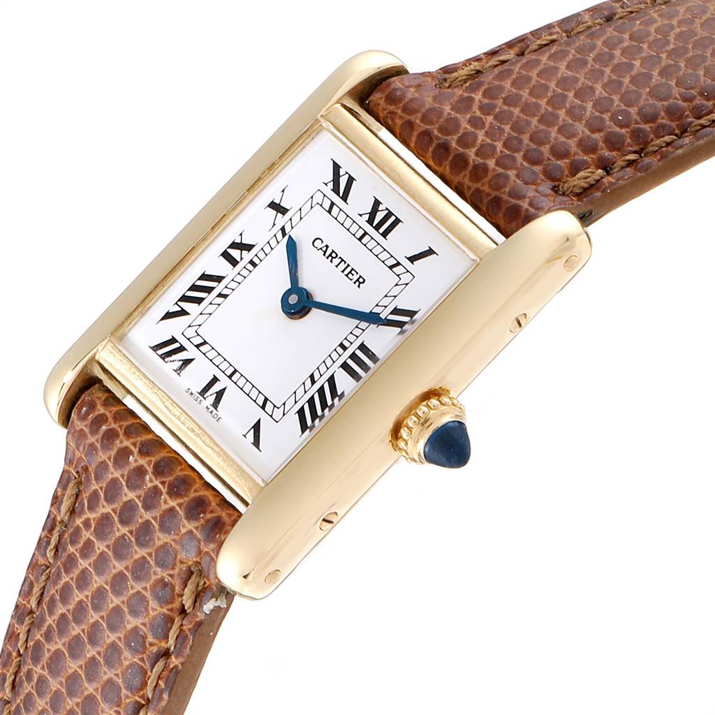 The image shows a Cartier Tank Classic Women's Yellow Gold White Dial Women's Yellow Gold White Dial watch at an angle, highlighting the face, crown, and part of the brown leather strap.