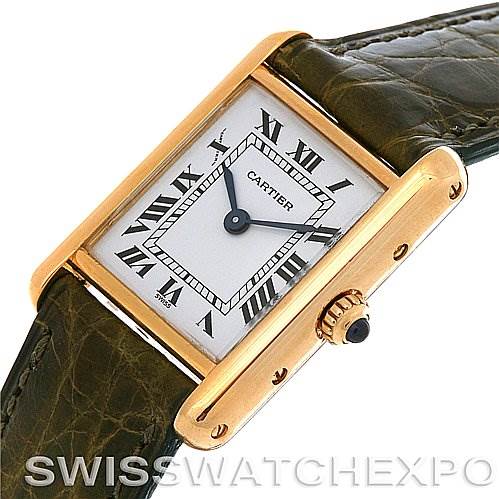 The image shows a Cartier Tank Classic Women's Yellow Gold White Dial Women's Yellow Gold White Dial watch from an oblique angle, highlighting the face, Roman numerals, and crown.