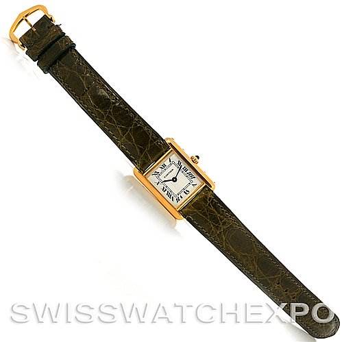 The image shows a top-down view of a Cartier Tank Classic Women's Yellow Gold White Dial Women's Yellow Gold White Dial watch, displaying its face, strap, and buckle.