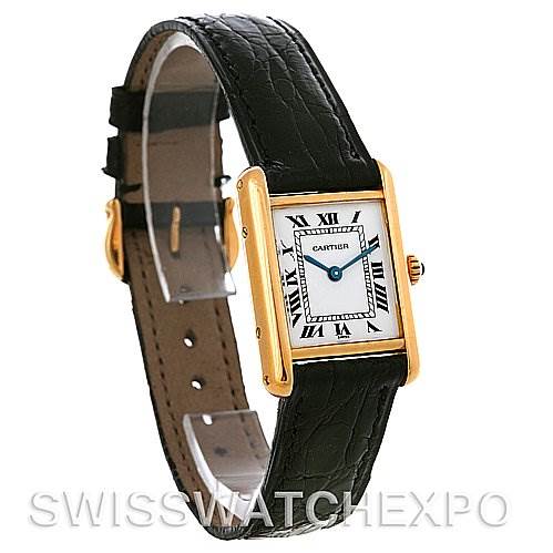 The image shows a Cartier Tank Classic Women's Yellow Gold White Dial Women's Yellow Gold White Dial watch at a slight angle, showcasing its rectangular gold case, white dial with Roman numerals, and black leather strap.