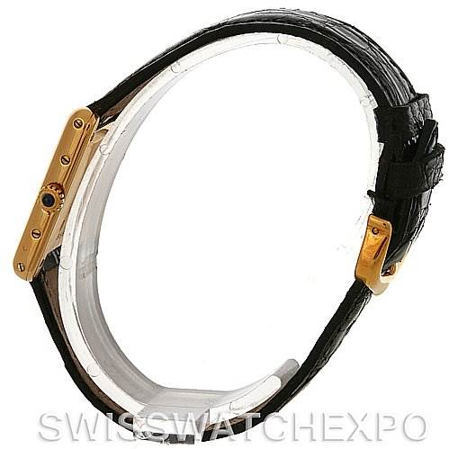 The Tank Classic by Cartier is shown from a side angle, displaying the strap, crown, and golden case details.