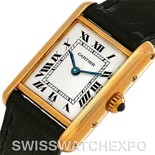 This image shows a Cartier Tank Classic Women's Yellow Gold White Dial Women's Yellow Gold White Dial watch at an angle displaying the face, crown, and part of the black leather strap.
