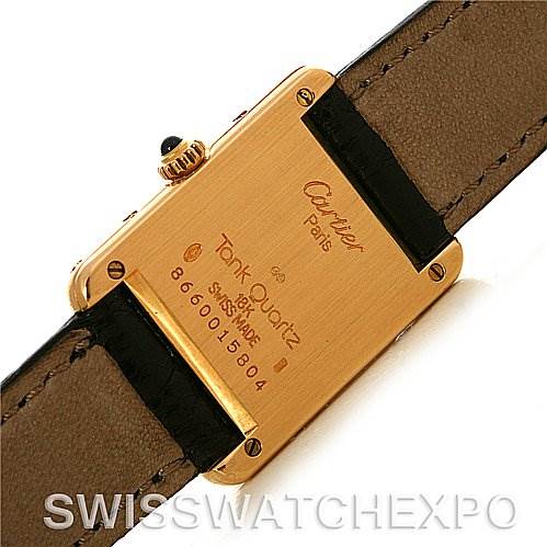 The image shows the back case and strap of a Cartier Tank Classic Women's Yellow Gold White Dial Women's Yellow Gold White Dial Quartz watch, displaying its model information and serial number.