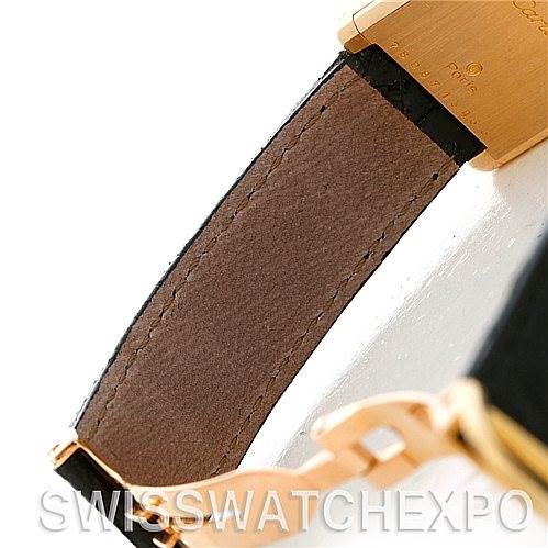This image shows a close-up view of the strap and buckle of a Cartier Tank Classic Women's Yellow Gold White Dial Women's Yellow Gold White Dial watch.