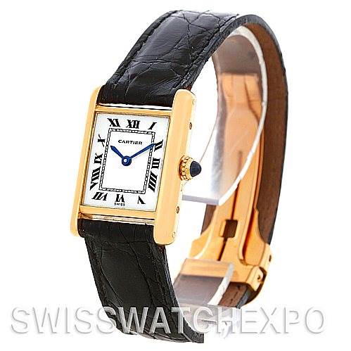 This Cartier Tank Classic Women's Yellow Gold White Dial Women's Yellow Gold White Dial watch is shown at a slight angle, displaying its rectangular face, black leather strap, and gold case.