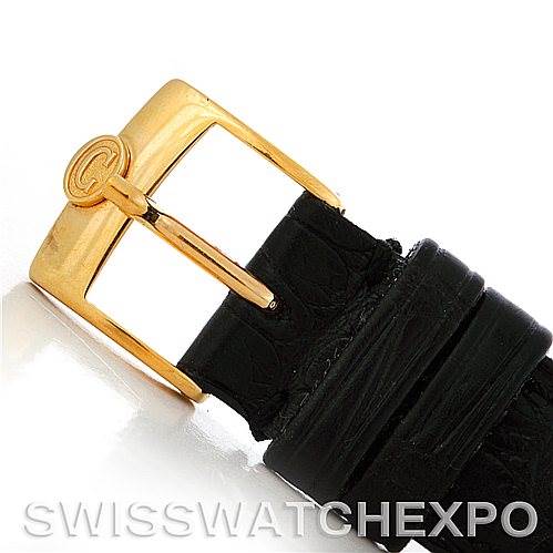 This image shows a close-up of the gold buckle and black leather strap of the Cartier Tank Classic Women's Yellow Gold White Dial Women's Yellow Gold White Dial watch.