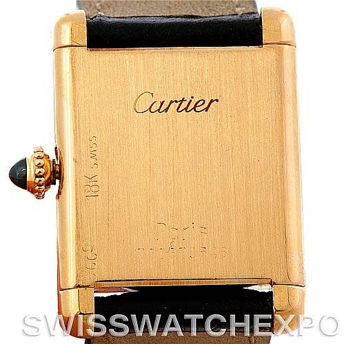 This image shows the back of a Cartier Tank Classic Women's Yellow Gold White Dial Women's Yellow Gold White Dial watch, highlighting its gold case, branding, and part of the strap.