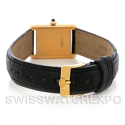 This image shows the back angle of a Cartier Tank Classic Women's Yellow Gold White Dial Women's Yellow Gold White Dial watch, highlighting its black leather strap and gold buckle.