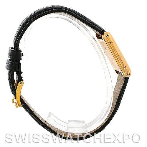 This image shows a side view of the Cartier Tank Classic Women's Yellow Gold White Dial Women's Yellow Gold White Dial watch, highlighting its gold casing and black leather strap.