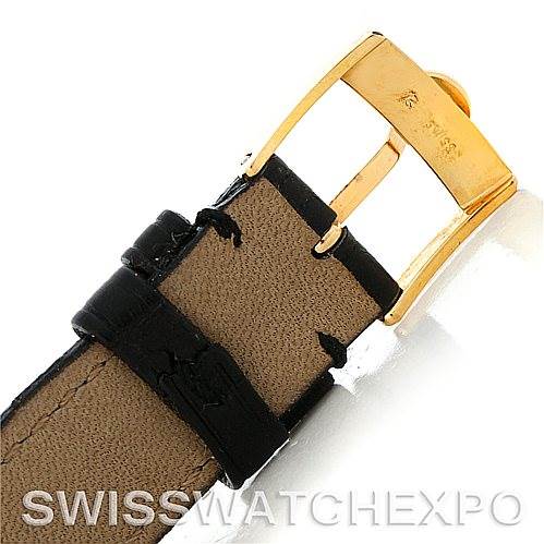 This image shows the buckle and part of the leather strap of a Cartier Tank Classic Women's Yellow Gold White Dial Women's Yellow Gold White Dial watch at a close-up angle.