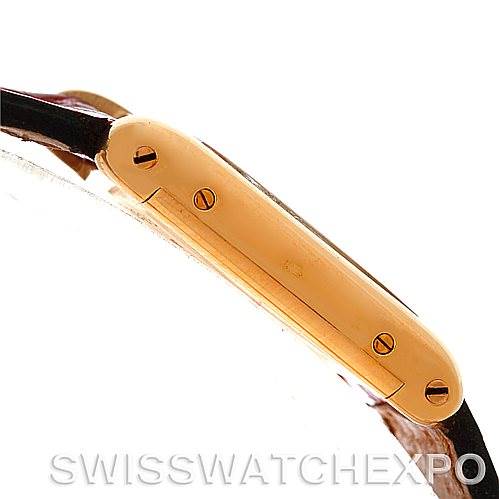 The image shows a side profile of the Cartier Tank Classic Women's Yellow Gold White Dial Women's Yellow Gold White Dial watch, highlighting the bezel and screws.