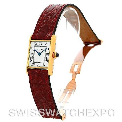 The image shows a side angle of a Cartier Tank Classic Women's Yellow Gold White Dial Women's Yellow Gold White Dial watch, highlighting the watch face and red leather strap.