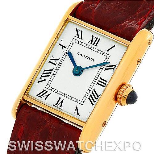 The image shows a close-up of the Cartier Tank Classic Women's Yellow Gold White Dial Women's Yellow Gold White Dial watch, showcasing its rectangular face, Roman numeral markers, and a side view of the crown.