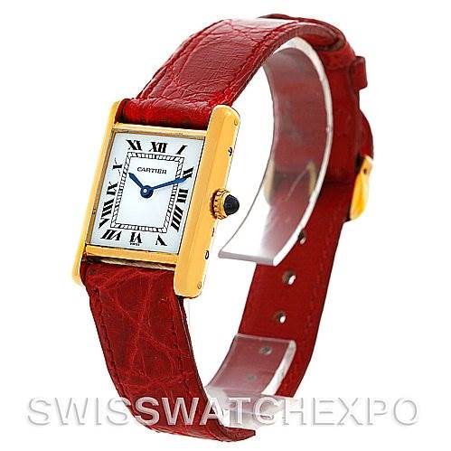 The Cartier Tank Classic Women's Yellow Gold White Dial Women's Yellow Gold White Dial watch is shown from a front-side angle, highlighting its rectangular face and red leather strap.