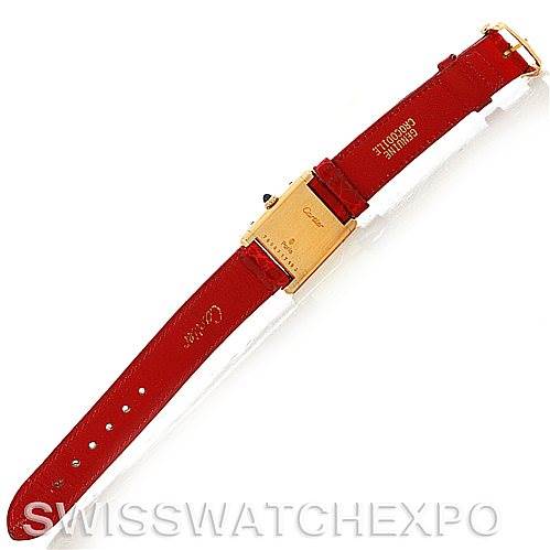 The image shows the back view of a Cartier Tank Classic Women's Yellow Gold White Dial Women's Yellow Gold White Dial watch with a red leather strap laid out flat.