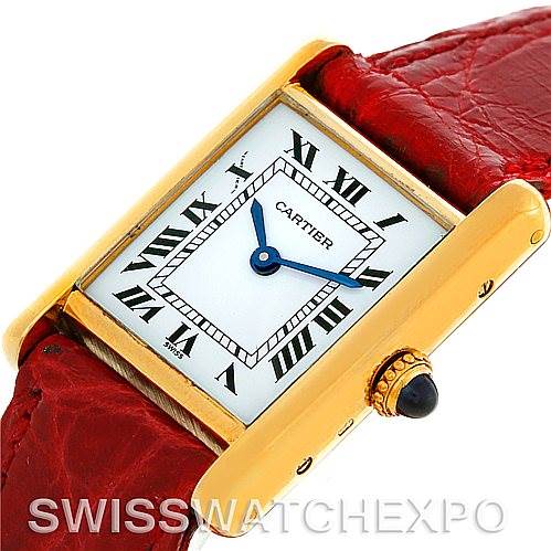 This image shows a close-up angle of a Cartier Tank Classic Women's Yellow Gold White Dial Women's Yellow Gold White Dial watch, highlighting its rectangular case, white dial, Roman numerals, and red leather strap.